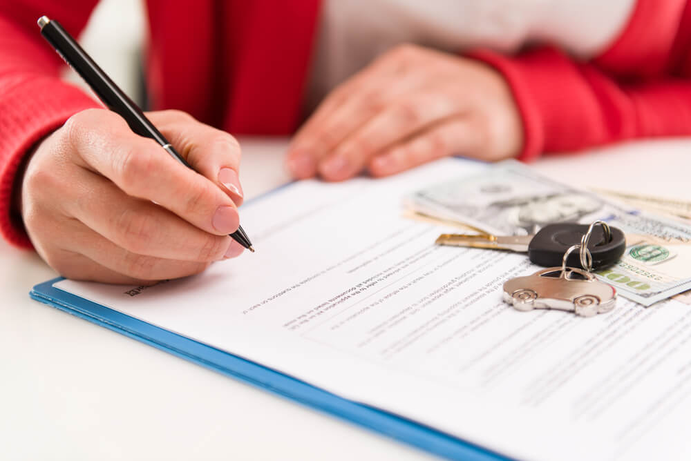 CloseUp Woman Auto Dealer Signing Rental